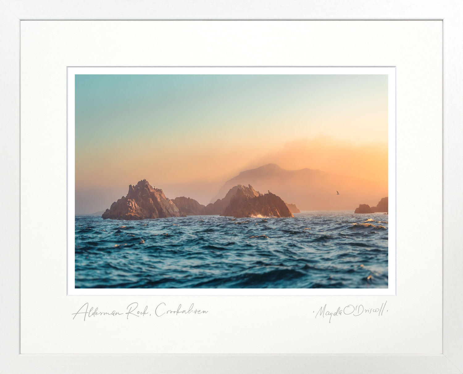 Sunset over ocean with rocky islands, framed artwork