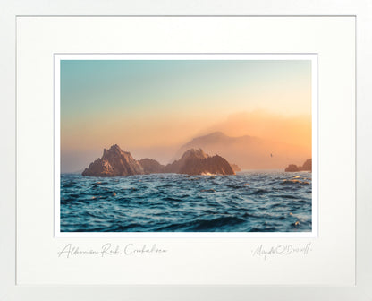 Sunset over ocean with rocky islands, framed artwork