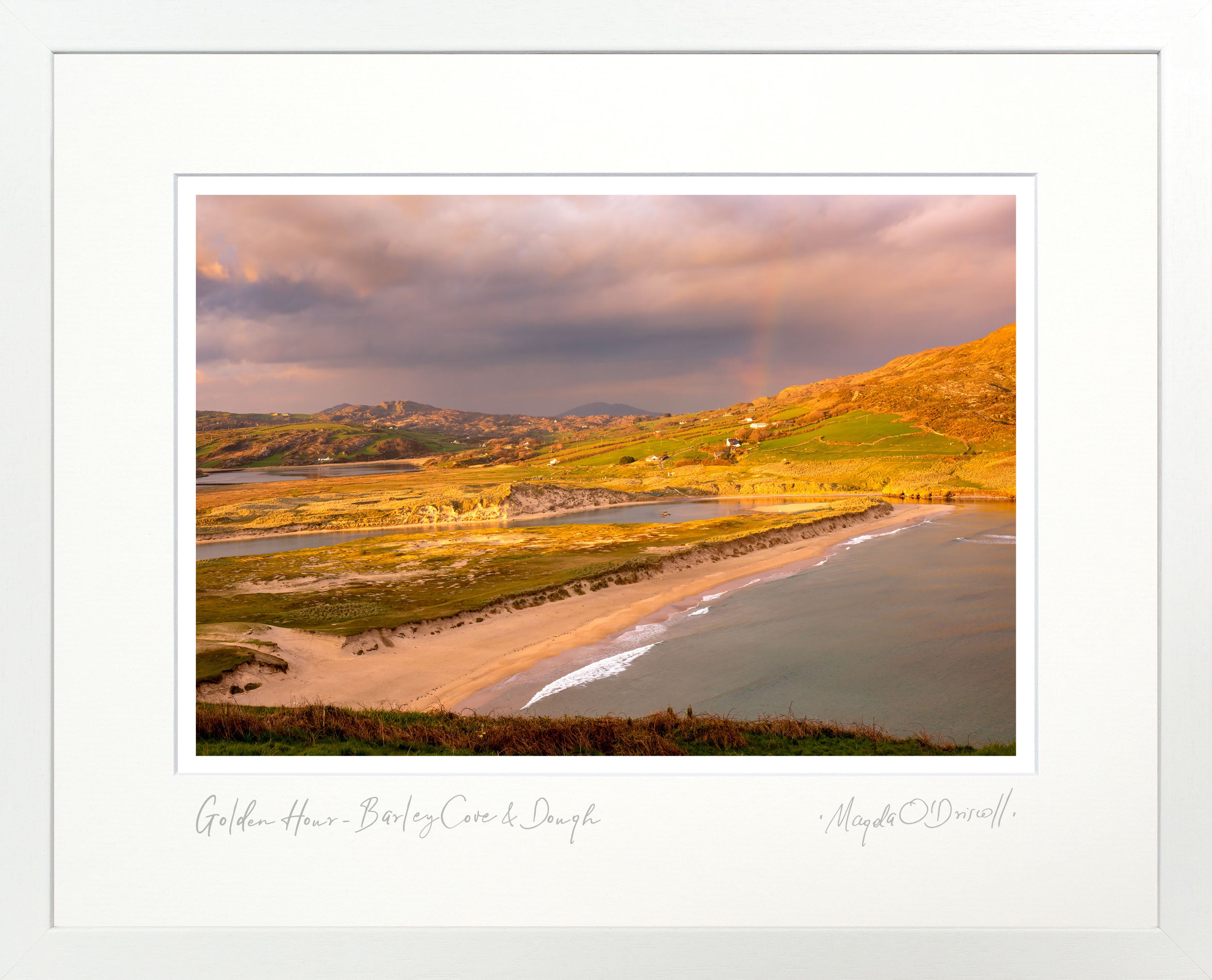 Scenic landscape with a beach and hills at sunset, framed with a white border.