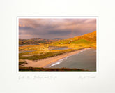 Scenic view of a beach and coastal landscape with a sunset or sunrise.